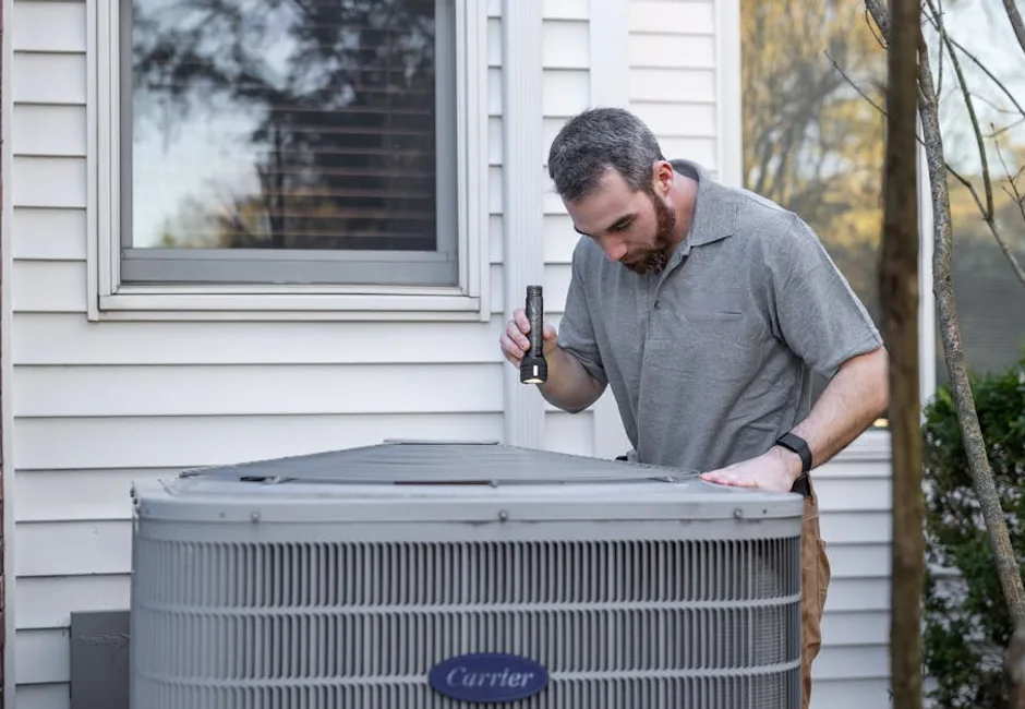 Technician comparing gas furnace and heat pump systems in a GTA home